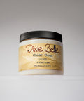 A jar of Dixie Belle Clear Coat Gloss with a black lid and beige label, containing 16 fl oz (473 ml) of product, is displayed against a plain, light background.