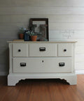 Dixie Belle Paint Buttercream Chalk Mineral Paint is the perfect paint for any DIY project!
Dresser painted in Buttercream Chalk Mineral Paint with black hardware. Staged with books,terracotta pots and a rusty H on top of on the dresser.