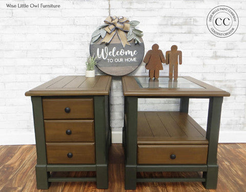 Two wooden side tables with a 'Welcome to our home' sign on a white brick wall background.