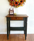 Autumn wreath above a wooden table with a white wall background