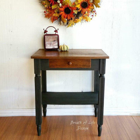 Autumn wreath above a wooden table with a white wall background