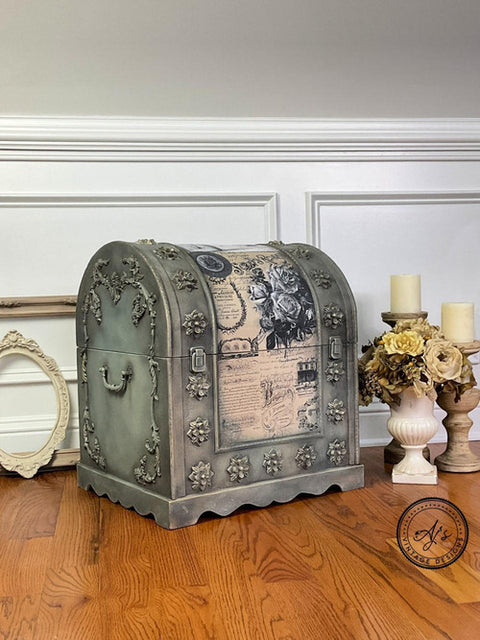 Dixie Belle Paint Dixie Dirt-4oz. 
Vintage chest with Dixie Belle Gravel Road Chalk Mineral Paint as the color base and Dixie Dirt used around the woodwork applique and hardware to give the piece more depth. Belles & Whistles Vintage Post - Transfer down the center of furniture. Stage on laminated wood flooring with 2 candle holders and a flower vase besides piece.