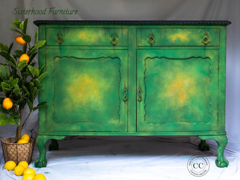 Dixie Belle Paint Evergreen Chalk Mineral Paint is the perfect paint for any DIY project! Green and yellow paint blended buffet with a black top. Small lemon tree placed next to the piece with lemons spilling out onto the floor.
