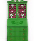 Dixie Belle Paint Evergreen Chalk Mineral Paint is the perfect paint for any DIY project! Green armoire makeover with gold handles containing white china. The inside is painted in a bright pink.