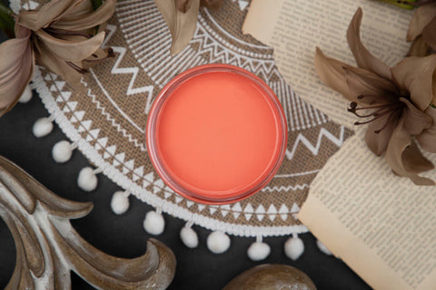 Dixie Belle Paint Flamingo Chalk Mineral Paint is the perfect paint for any DIY project!
Opened container of  Flamingo Chalk Mineral Paint staged with book pages, brown flower and a brown and white boho rug.