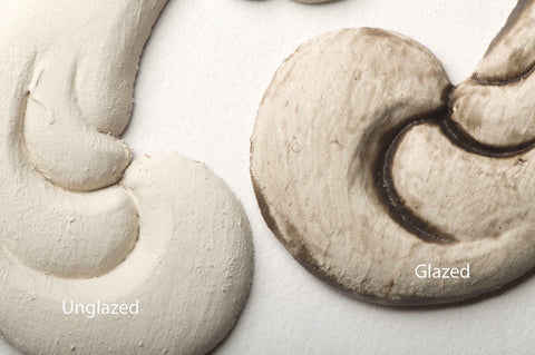 Dixie Belle Paint Grunge Glaze 
This shows two appliques painted white.  One is unglazed and one is glazed in the Grunge Glaze.  The pieces have Unglazed and Glazed over the appropriate applique.