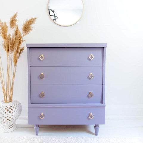 Dixie Belle Paint Lucky Lavender Chalk Mineral Paint is the perfect paint for any DIY project!
Beautiful white minimalistic stage with a dresser painted in Lucky Lavender Chalk Mineral Paint and gold hardware