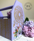 Dixie Belle Paint Lucky Lavender Chalk Mineral Paint is the perfect paint for any DIY project!
Wooden toolbox painted in Lucky Lavender Chalk Mineral Paint with the Mudcloth Stencil on the front of the box and Western Boho - Silkscreen Stencil on the side. Staged with pink & purple flowers.