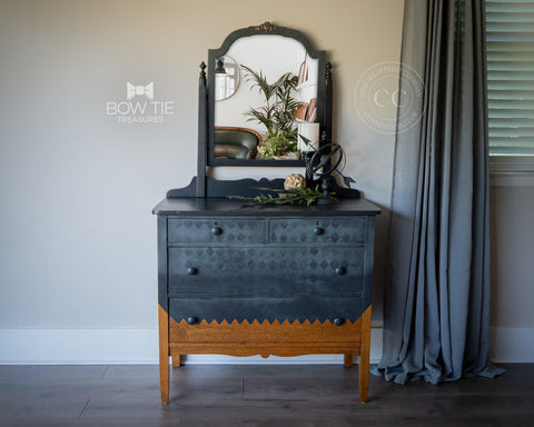 Dixie Belle Paint Midnight Sky Chalk Mineral Paint is the perfect paint for any DIY project! Before and after Black Chalk painted dresser with mirror and checkered stencil painted on front. staged with a candle holder, a wicker ball and a sphere with an arrow through it.