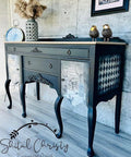 Dixie Belle Paint Midnight Sky Chalk Mineral Paint is the perfect paint for any DIY project! Black Chalk painted entry table with Vintage newspaper decoupage and checkered stencil on the side. Staged with a  bird figure and vase with wheat in it.