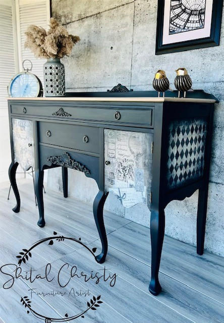 Dixie Belle Paint Midnight Sky Chalk Mineral Paint is the perfect paint for any DIY project! Black Chalk painted entry table with Vintage newspaper decoupage and checkered stencil on the side. Staged with a  bird figure and vase with wheat in it.
