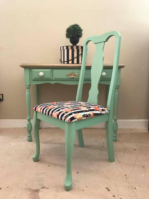 Dixie Belle Paint Mint Julep Chalk Mineral Paint is the perfect paint for any DIY project!
Mint Chalk Painted desk and chair with a  black and white strip patterned with pink and gold paint splatter fabric on top of chair. Staged with  a Black and white stripe box and plant on top.
