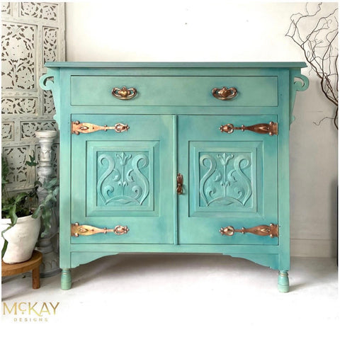 Dixie Belle Paint Mint Julep Chalk Mineral Paint is the perfect paint for any DIY project! Mint chalk painted end table with gold hardware. Staged next to a potted plant.