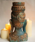 Dixie Belle Paint Patina Spray. Back of Buddha head painted and sprayed to look rusty. Staged in front of candles.