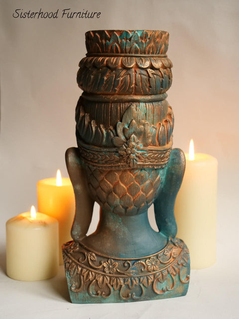Dixie Belle Paint Patina Spray. Back of Buddha head painted and sprayed to look rusty. Staged in front of candles.
