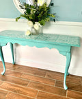 Dixie Belle Paint Sea Glass Chalk Mineral Paint is the perfect paint for any DIY project! A table that is painted in sea glass with a white stencil on top.