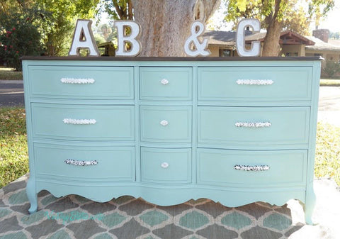 Dixie Belle Paint Sea Glass Chalk Mineral Paint is the perfect paint for any DIY project! A dresser painted in sea glass with silver hardware and is staged outside.
