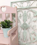 Dixie Belle Paint Soft Pink Chalk Mineral Paint is the perfect paint for any DIY project! A wooden chair with a heart of the top middle of the back and the chair is painted in soft pink chalk mineral paint with a distressed look on the edges.