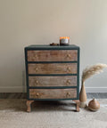 Dixie Belle Paint Stormy Seas Chalk Mineral Paint is the perfect paint for any DIY project!
Small dresser with wood drawers and the rest of the body is painted in Stormy Seas Chalk Mineral Paint with gold hardware. Staged with a burning candle on top.