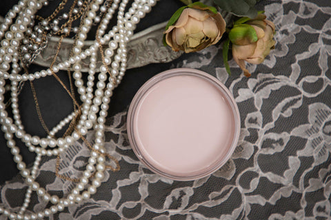 Dixie Belle Paint Tea Rose Chalk Mineral Paint is the perfect paint for any DIY project!
Opened container of Tea Rose Chalk Mineral Paint staged with pearls, lace cloth, and roses.