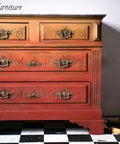 Dixie Belle Paint Terracotta Chalk Mineral Paint painted furniture piece, three drawers with an ombre effect.  Three bananas are floating to the right of the painted furniture piece