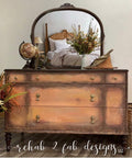 Dixie Belle Paint Terracotta Chalk Mineral Paint is the perfect paint for any DIY project!  A brown chalk painted dresser with dark edges and a mirror on the top.