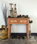 Dixie Belle Paint Terracotta Chalk Mineral Paint is the perfect paint for any DIY project!  A brown chalk painted and distressed hallway table with pine cones, baskets and winter decorations.