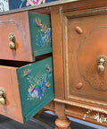 Dixie Belle Paint Terracotta Chalk Mineral Paint is the perfect paint for any DIY project!  A brown chalk painted buffet table with rub-on furniture transfers applied to the sides of the drawers.