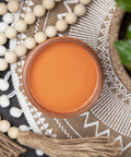 Dixie Belle Paint Terracotta Chalk Mineral Paint is the perfect paint for any DIY project!  An open jar of Dixie Belle Paint Terracotta Chalk Mineral Paint sitting on a table with beads and tassels.