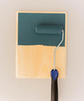 Smooth Roller being used on a wood board with a greenish blue paint.