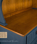 A close-up of a wooden cabinet with a blue painted body and a warm golden-brown wood top. A label reads “American Honey and Golden Ash 50/50 mix.” Gracie's House Painted Furniture watermark is at the bottom.