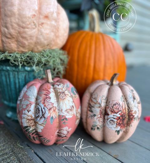 Decorative pumpkins with floral patterns on a wooden surface, featuring the brand 'Leah Kendrick Designs'.