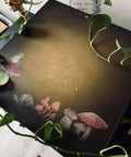 Brownish black painted furniture blended with some tan in the middle. The Cottagecore Mushrooms Silkscreen Stencil has been applied to the center. Mr. Toad's Happy Place Transfer has also been applied to the top of this piece. Vines of a pothos plant spread out on top of the piece.
