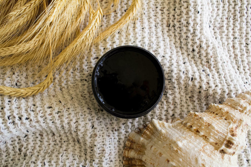 Anchor Silk All-In-One paint is perfect for painting kitchen cabinets, bathroom cabinets and painting furniture. Open container of Anchor Silk All-In-One Mineral Paint staged on beach blanket with shell and beach grass.
