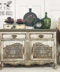 Hampton Olive Silk All-In-One paint is perfect for painting kitchen cabinets, bathroom cabinets and painting furniture.
Credenza with a white farmhouse distressed look, on both door panels its painted with Hampton Olive Silk All-In-One paint along with the Victorian Damask - Stencil in white on top of the Hampton Olive.