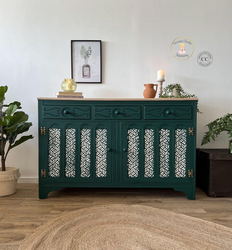 Midnight Green Silk All-In-One paint is perfect for painting kitchen cabinets, bathroom cabinets and painting furniture. Dark green Silk all in one painted hutch with stencil painted white on the doors. Staged with books, candles a terra pitcher and potted trailing ivy.