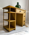 Mojave Silk All-In-One paint is perfect for painting kitchen cabinets, bathroom cabinets and painting furniture. Yellow Silk painted desk with black hardware and staged with a green glass vase.