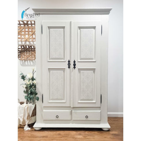 Oyster Silk All-In-One paint is perfect for painting kitchen cabinets, bathroom cabinets and painting furniture. White  Silk All-In-One painted armoire with black hardware. Staged with tobacco basket and plants.