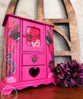 Prickly Pear Silk All-In-One paint is perfect for painting kitchen cabinets, bathroom cabinets and painting furniture. Pink chalk painted jewelry box with rose rub on transfers Staged next to a purple flower.