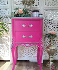 Prickly Pear Silk All-In-One paint is perfect for painting kitchen cabinets, bathroom cabinets and painting furniture. Pink chalk painted end table with silver painted on the trim and hardware. Staged with florals and the paint jars on top.