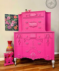 Prickly Pear Silk All-In-One paint is perfect for painting kitchen cabinets, bathroom cabinets and painting furniture. Pink chalk painted dresser with silver paint on the trim and legs. Staged with a pink floral jewelry box and colorful wicker  vase.