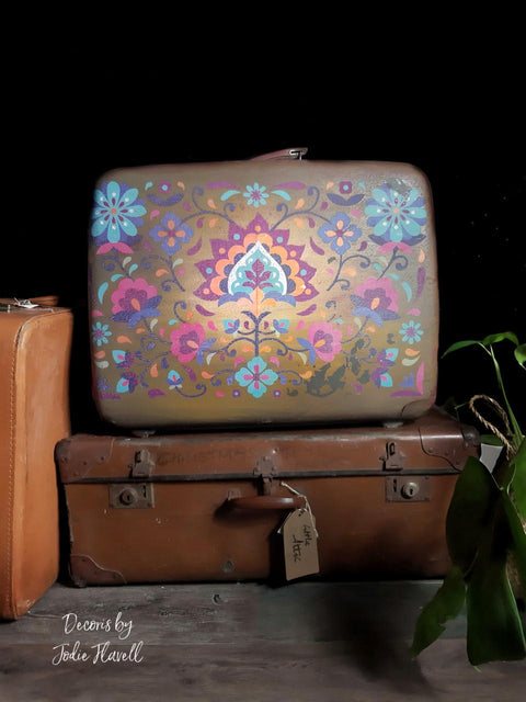 Umber Silk All-In-One paint is perfect for painting kitchen cabinets, bathroom cabinets and painting furniture.  Three old brown chalk painted suitcases, one with a transfer applied to the front of it.  Sitting on a wooden floor with a green plant next to them.