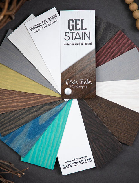 A fanned-out display of Dixie Belle Paint Company gel stain samples shows various colors on wood, including brown, red, blue, green, gray, and white. The samples highlight both water-based and oil-based options.