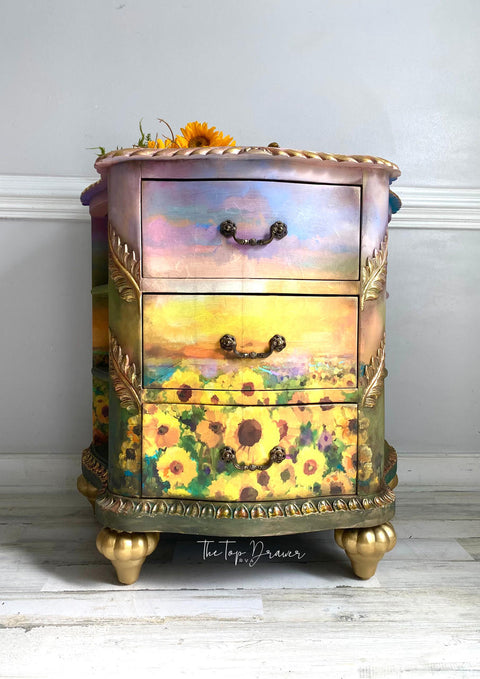 Belles and Whistles Sunflower Sunset - A1 Rice Decoupage Paper , three drawer side table with the sunflower sunset rice decoupage paper on the front.  staged with sunflowers on top