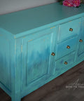 Cerulean Blue Terra Clay Paint provides endless possibilities for your imagination and can be used on wood, canvas, tile, fabric and more!
Entertainment center cabinet painted in Cerulean Blue Terra Clay Paint as well as Blue Agave, Lani Lagoons, Blue Moon and Malachite used in layers and a gradient between the colors. .