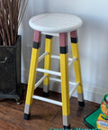 Terra Clay Paint Daffodil Terra Clay Paint provides endless possibilities for your imagination and can be used on wood, canvas, tile, fabric and more! A stool that resembles a note book and pencil. The top is white ans painted with lines like the notebook paper and the top of the legs are painted pink for the eraser, then painted in daffodil to resemble a pencil and then black on the bottom to resemble the lead.