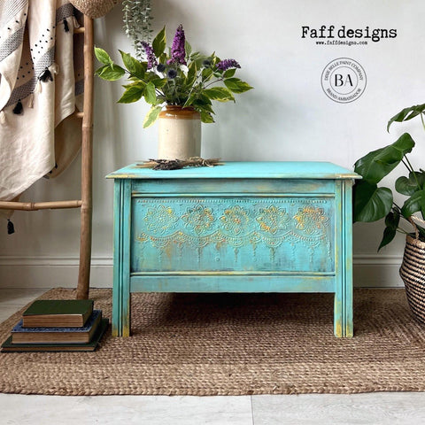 Lani's Lagoon Terra Clay Paint provides endless possibilities for your imagination and can be used on wood, canvas, tile, fabric and more!

Coffee table painted in Lani's Lagoon Terra Clay Paint with Lotus Bloom - Stencil raised using the Dixie Mud along with yellow streaks along the stencil and the piece . Staged on a woven carpet , a flower pot with greenery and flowers.