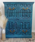London Blue Terra Clay Paint provides endless possibilities for your imagination and can be used on wood, canvas, tile, fabric and more! 
Chest of Drawers painted using layers of  Elderberry ,Galaxy, London Blue and Cerulean Blue Terra Clay Paint is used as a highlight around the piece accented with chain-link gold hardware. Staged besides two neutral colored vases with neutral feathers.