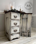 Moon Beam Terra Clay Paint provides endless possibilities for your imagination and can be used on wood, canvas, tile, fabric and more! End tables distressed and Painted cream with terra Paint and trees painted on the side. Staged with wreath and candles.