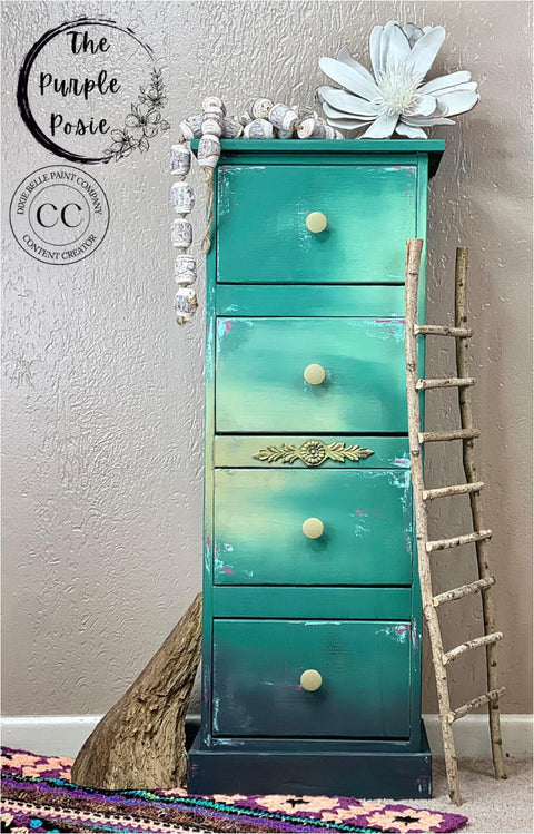 Onyx Terra Clay Paint provides endless possibilities for your imagination and can be used on wood, canvas, tile, fabric and more! Blue Ombre painted tall end table with black clay paint on the bottom. Staged with wood ladder, wood beads and flowers.